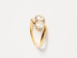a close up of a diamond ring on a white surface
