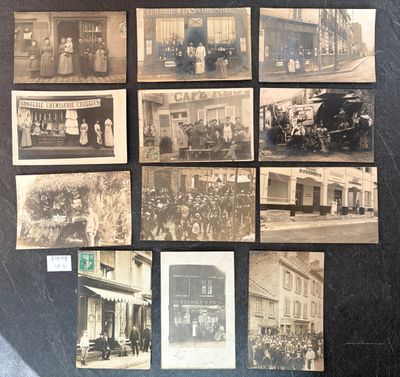 several old black and white photographs of people and vehicles on a wall