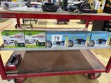 a cart with a lot of items on it in a store