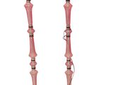 pair of pink glass candlesticks on tripod legs