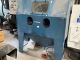 a machine that is sitting in a room with a lot of tools