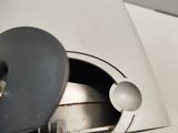 a close up of a metal object on a white surface