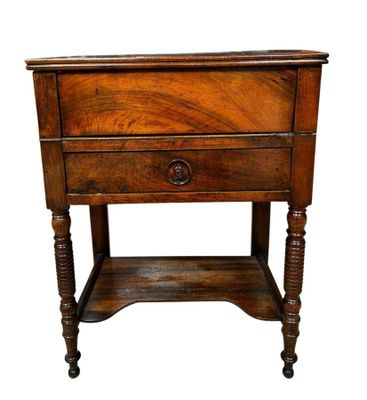 an old wooden table with a drawer on top of it