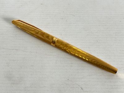 an image of a pen sitting on top of a white surface