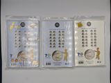 three packs of silver coins in plastic bags on a white surface