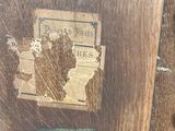 a close up of a piece of wood with a sign on it