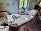 a couch with many pillows on it in a room