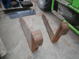 two pieces of wood sitting on the ground next to a tractor
