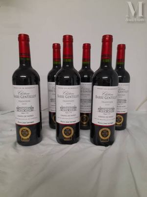 four bottles of wine are lined up on a table