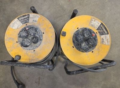 two yellow hoses sitting on top of a cement floor next to each other