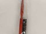 a red toothbrush and a black toothbrush in a plastic bag