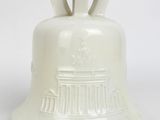 a white bell with a crown on top of it