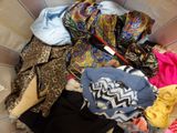 a basket full of clothes that is sitting on the floor