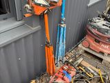 a pile of tools that are sitting outside of a building