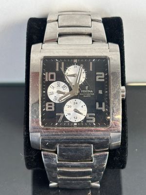 a close up of a watch on a black surface
