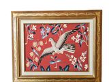 tableau encadré, réalisé au point de croix, représentant une mouette en plein vol sur fond rouge