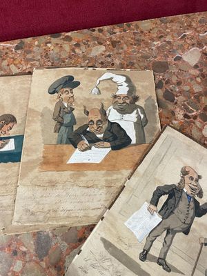several old books with pictures of people on them on a table