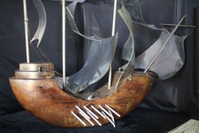 une maquette en bois d'un bateau exposée dans une vitrine