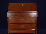 an antique wooden chest of drawers with brass handles