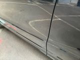 a close up of a car ' s door handle and the door handle of the car