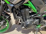 a close up of a green motorcycle parked on the street