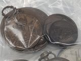 four different types of pocket watches on a plastic bag