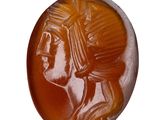 an image of a carved button with a man ' s head on it