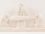 a white statue of a woman laying on a bed