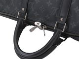 a close up of a black louis vuitton bag on a white background