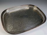 a silver tray with a handle on a white table