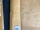 two old books are sitting on top of a blue table