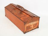 an old rusted suitcase sitting on a white surface
