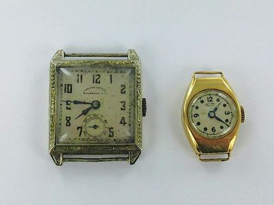 an image of a couple of watches sitting next to each other on a table