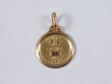 a close up of a gold coin with a diamond on it