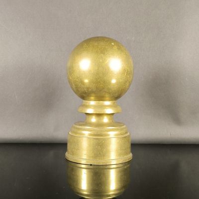 a close up of a golden ball on top of a black table