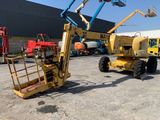 a yellow crane that is sitting in the middle of a parking lot