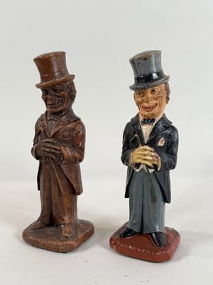 two figurines of a man and a woman in top hats