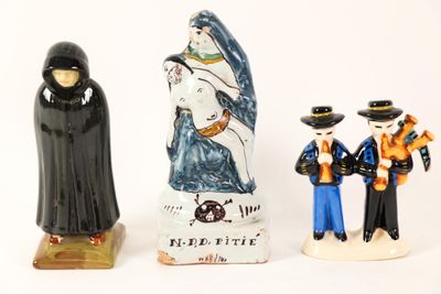 three figurines of people standing next to each other