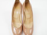 a close up of a pair of nude colored shoes on a white surface