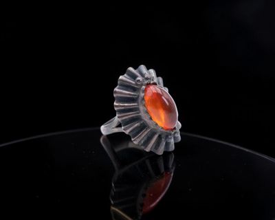 an image of a ring with a red stone in it