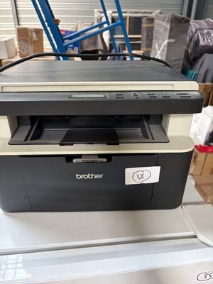 a black and white printer sitting on top of a box