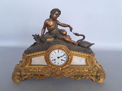 a gold clock with a statue of a woman sitting on top of it
