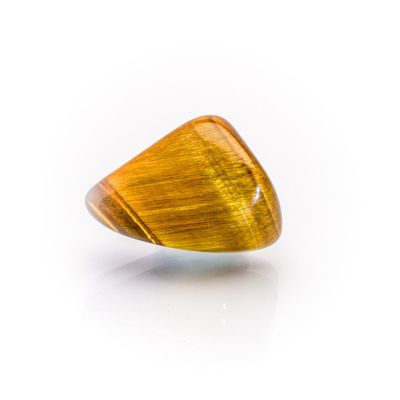 a close up of a yellow tiger eye stone on a white surface