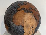 a basketball ball with a map of the world painted on it