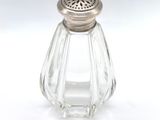 a glass salt and pepper shaker on a white surface