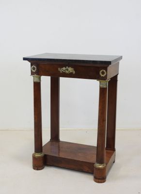 an image of a small wooden table with a black top