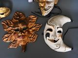 three masks that are sitting on a table
