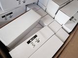 several white boxes are stacked on top of each other in a cardboard box