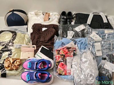 a lot of clothing and shoes that are on a table