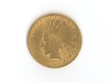 a gold coin with an indian head on it on a white surface